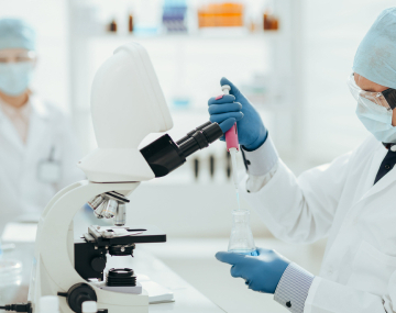 Laboratory technician working with microscope